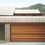 Domestic dwelling incorporating multiple materials including stone walls and courtyard garden.