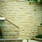 Huge depth of a natural sandstone retaining wall demonstrating its structural strength and natural qualities of texture and soft colours.
